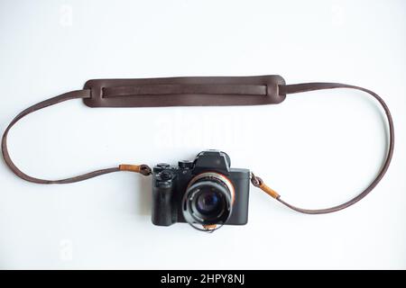 Genuine leather camera strap handmade with mirrorless camera on white background Stock Photo