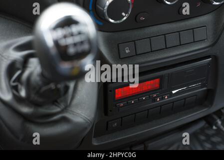 Blurred shot of a gear shifter in the background of a digital tachograph from an angle. Stock Photo