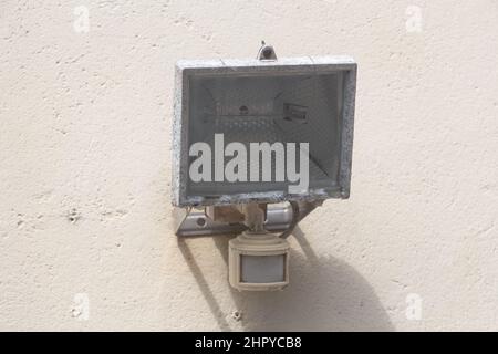 Outdoor floodlight with a motion detector on the wall of a garage Stock Photo