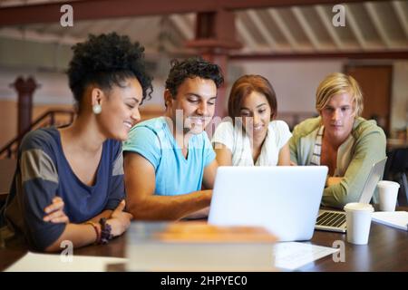 Working together to prepare for finals. A group of young people studying together for the upcoming exams. Stock Photo