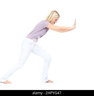 Lets get this out the way. Pretty young woman pushing a obstacle out of the way. Stock Photo