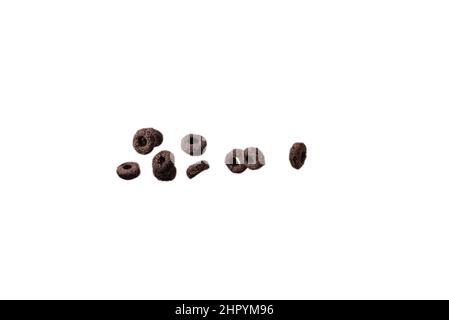 Chocolate rings cereal spill out into a bowl. Breakfast. Isolated on a white background. Stock Photo