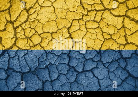 Ukrainian national flag pattern cracked earth, war concept Stock Photo