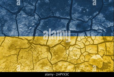 Ukrainian national flag pattern cracked earth, war concept Stock Photo