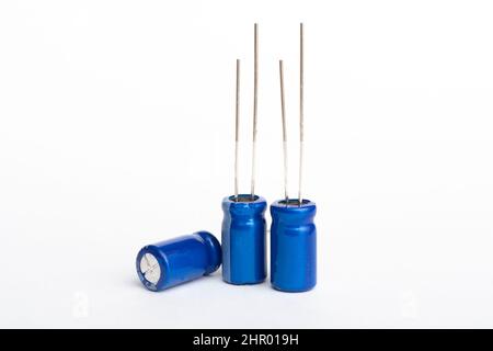 Three blue electrolytic capacitors isolated on white background Stock Photo