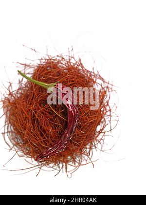 Chilli threads and chilli pod against white background Stock Photo
