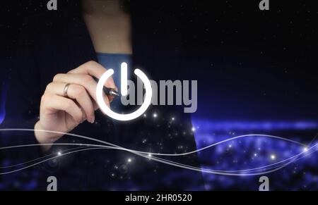 Start up business concept. Power up concept.Hand holding digital graphic pen and drawing digital hologram pressing button on virtual screen sign on ci Stock Photo