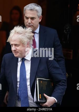 Prime Minister Boris Johnson leaves 10 Downing Street in London, followed by his Chief of Staff Stephen Barclay, to update MPs in the House of Commons on the latest situation regarding Ukraine, following Russia's invasion. Picture date: Thursday February 24, 2022. Stock Photo