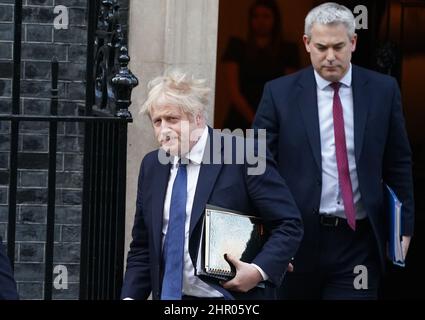 Prime Minister Boris Johnson leaves 10 Downing Street in London, followed by his Chief of Staff Stephen Barclay, to update MPs in the House of Commons on the latest situation regarding Ukraine, following Russia's invasion. Picture date: Thursday February 24, 2022. Stock Photo