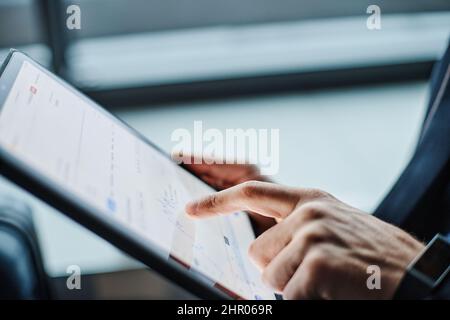 businessman analyzing a graph of financial growth on his tablet. Stock Photo