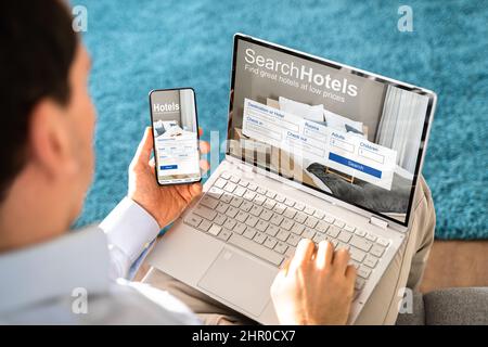 Person Holding A Smart Phone Using Online Low Prices Hotels Application Stock Photo