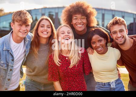 Group Of University Or College Students Outdoors On Campus Smiling And Looking At Camera Stock Photo