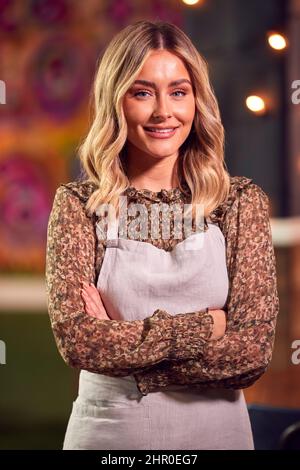 Portrait Of Smiling Female Server Working Night Shift In Bar Restaurant Or Club Stock Photo