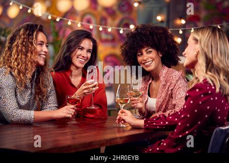 Multi-Cultural Group Of Female Friends Enjoying Party Night Out In Bar Stock Photo