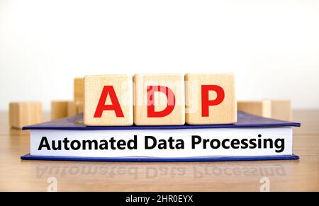 ADP automated data processing symbol. Concept words ADP automated data processing on cubes on book on a beautiful white background. Business and ADP a Stock Photo