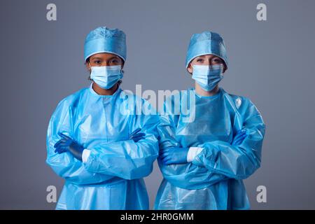 Studio Portrait Of Two Female Lab Research Workers In PPE Stock Photo