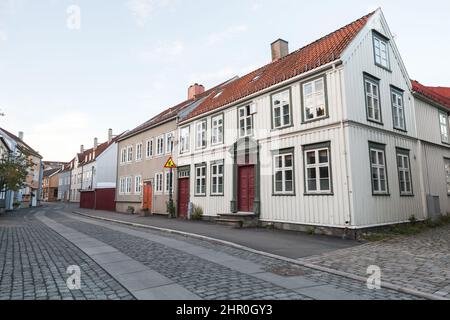 Old Scandinavian wooden houses stand along the street in Trondheim, Norway Stock Photo
