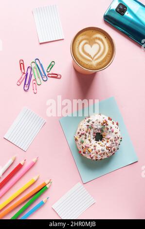 Coffee break with donut on the pink table background Stock Photo