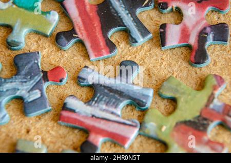 Close up view of jigsaw pieces scattered on a calk background. Stock Photo