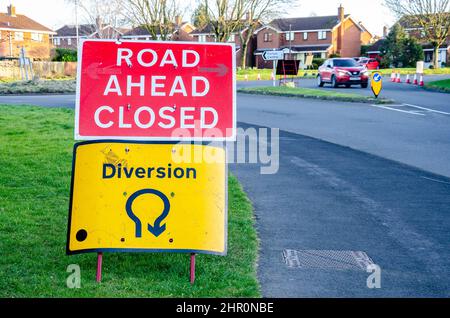 Road signs warning motorists of diverted traffic and road closures due to roadworks. Stock Photo