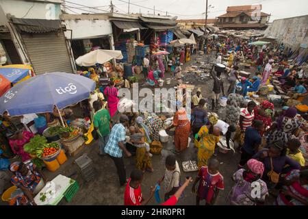 Residents of Saint Louis, Senegal shop in a busy public street marketplace. West Africa. Stock Photo