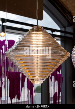 Glass pendant light by the name Press, hanging in the Tom Dixon flagship store and showroom at Coal Drops Yard, Kings Cross, London UK. Stock Photo