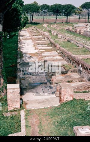 Ostia Antica - large archaeological site in progress, location of the harbour city of ancient Rome.  Piazzale delle Corporazioni (Square of the Corporations) Merchant’s (guilds’) mosaics.  Archival scan from a slide. April 1970. Stock Photo