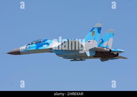 Ukrainian Air Force Sukhoi SU-27 military fighter jet in the air in front of blue sky Stock Photo