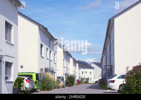 road with newly built semi detached housing Stock Photo