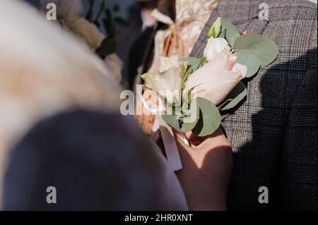 Boutonniere on the groom's jacket Stock Photo