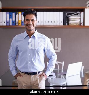 Hes ready for whatever the business world throws at him. Cropped shot of a handsome young businessman in his office. Stock Photo