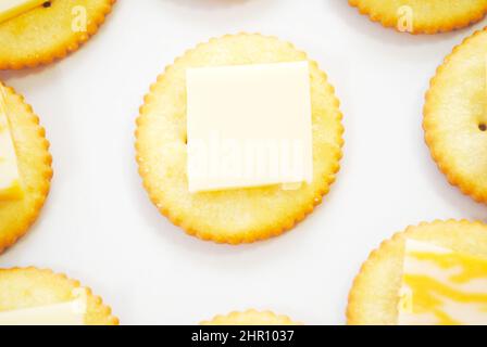 Round Salty Crackers with Sliced Cheese on Top Stock Photo