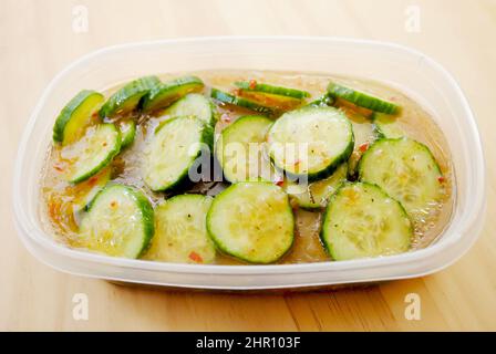 Sliced Cucumbers Marinated in Italian Dressing for a Healthy Snack Stock Photo