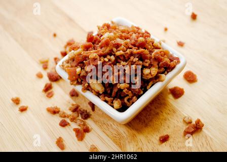 Crisy Bacon Bit Overflowing from a Square White Bowl Stock Photo