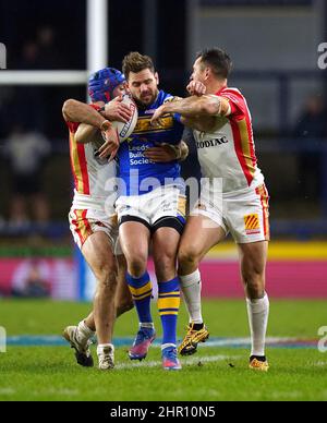 Leeds Rhinos' Aidan Sezer (centre) tackled by Catalans Dragons' Benjamin Jullien (left) and Mitchell Pearce (right) during the Betfred Super League match at Headingley Stadium, Leeds. Picture date: Thursday February 24, 2022. Stock Photo