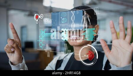 Digital interface with medical data processing against african american woman wearing vr headset Stock Photo