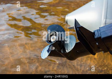 Fishing Boat Outboard Motor Propeller, Outboard Motor on a Pleasure boat, lake, river. Stock Photo