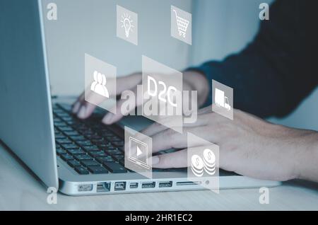 hand typing on computer laptop icon symbol Direct to Consumer D2C virtual screen Internet Business big data Technology Concept. Stock Photo