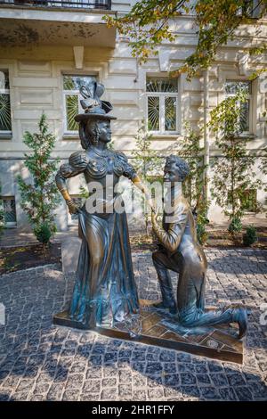 The Za Dvumya Zaitsami Monument, statue of a man on his knee proposing marriage to a woman, Desyatinnaya Street, Kiev (Kyiv), capital city of Ukraine Stock Photo