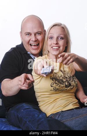couple enjoys a cozy evening watching TV Stock Photo