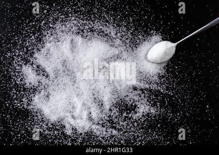 Spoon with white sugar on the dark background and copy space Stock Photo