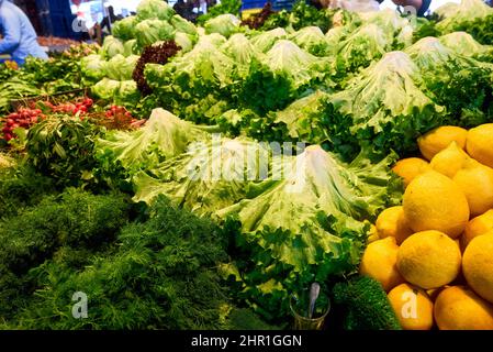 Fresh green salad leaves in variety assortment of colorful vegetables in market Stock Photo