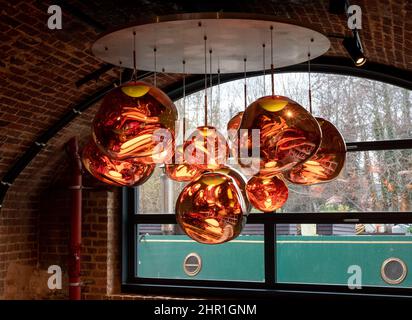 Glass pendant lights by the name Melt, hanging in the Tom Dixon flagship store and showroom at Coal Drops Yard, Kings Cross, London UK. Stock Photo