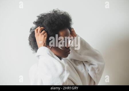 Portrait of a woman with a dab of cream on her face Stock Photo