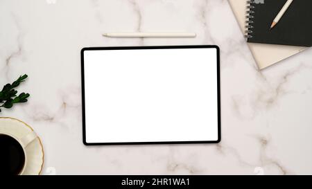 Minimal white marble office desk background with portable tablet empty screen mockup, stylus pen, notebooks, and decor. top view, flat lay Stock Photo