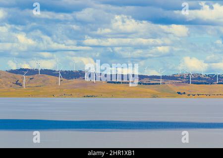 Lake George in New South Wales, Australia, seen from the Weereewa Lookout with the wind turbines of the Capital Wind Farm seen in the distance. Stock Photo