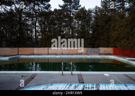 A dirty swimming pool filled with water. This house has been demolished. Stock Photo