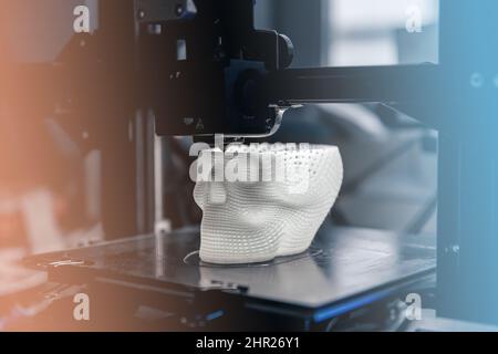 The 3D printer prints white plastic model Stock Photo