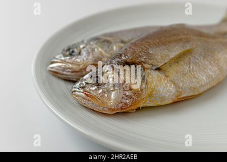 dried yellow croaker on a white background Stock Photo