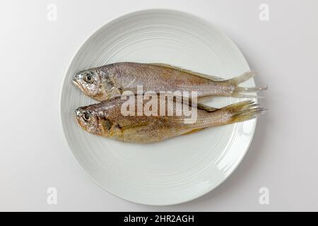dried yellow croaker on a white background Stock Photo